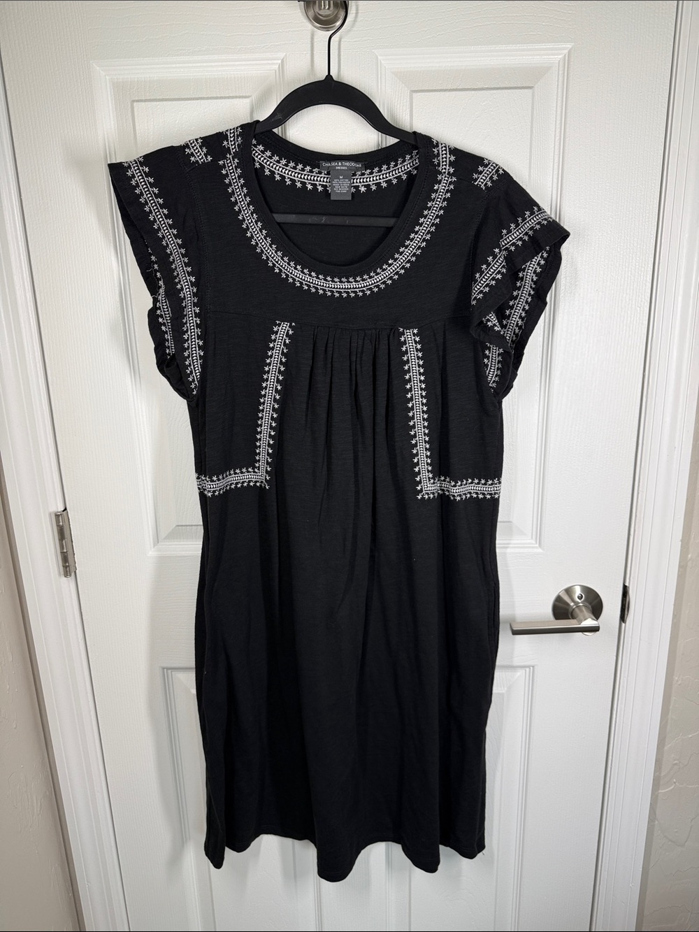 Chelsea & Theodore black casual dress with white embroidered accents size medium